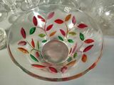 a glass bowl with a candle inside of it on a table