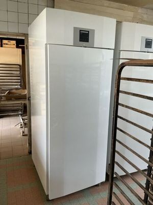 two white refrigerators in a kitchen next to each other
