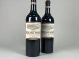 two bottles of red wine sitting next to each other on a table