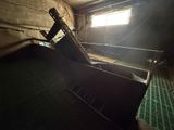 a room with a ladder and a window in it