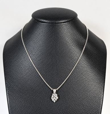 a close up of a necklace on a mannequin with a white background