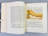 an open book with a picture of a woman laying on a bed