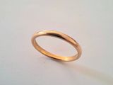 a close up of a gold ring on a white surface