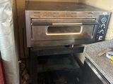 a small oven that is sitting in the corner of a kitchen