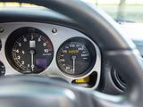 a close up of a car dashboard with a speedometer and gauges