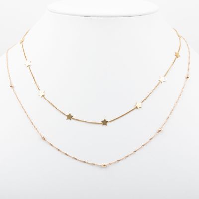 un collier en or orné d'étoiles sur un mannequin blanc