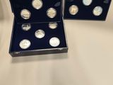a couple of silver coins sitting in a box on top of a table