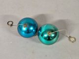 pair of blue and green christmas ornaments on a white surface