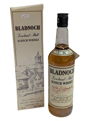a bottle of blended scotch whisky next to a cardboard box