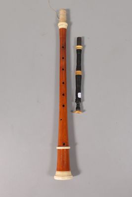 an old recorder with a wooden handle and a wooden stick