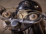 a close up of a motorcycle handlebar with a clock on it
