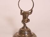 an image of a silver plate with a ring on it