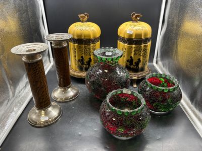 many different glass vases and candles on the table