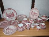a table with a lot of red and white plates and cups