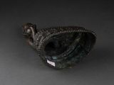 bronze figurine of a woman holding a bird ' s beak