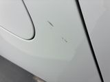 a white car with a hole in the side of it