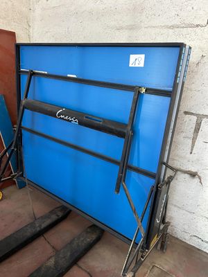 une porte bleue sur laquelle est accrochée une pancarte, à côté d'un escalier