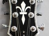 a close up of a guitar head with a black and white design