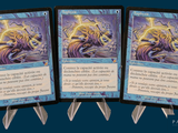 three cards of a card game are displayed on a stand