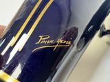 a close up of a person holding a blue and gold motorcycle