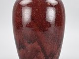 a red apple that is sitting on a white surface