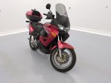 a red motorcycle that is parked in a white room