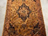 an antique persian rug on the floor in a living room