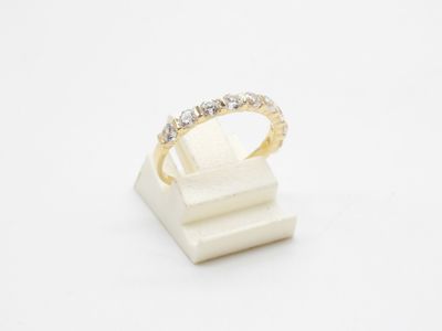 a white and yellow gold ring with diamonds on a white surface