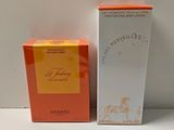 an orange and white box of perfume next to a white box of perfume