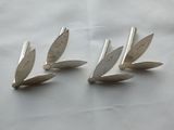 four silver spoons sitting on top of a white table cloth
