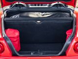 a red car with its trunk open on the street