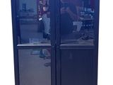a glass door with a reflection of a person in it