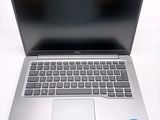 an open laptop computer sitting on top of a white table
