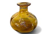 a yellow vase with a picture of a man riding a horse on it
