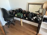 a desk with a chair and a desk top with a helmet on it