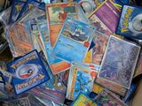 a cardboard box filled with lots of pokemon cards