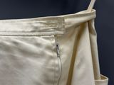 the bottom of a pair of beige pants with a zipper on it