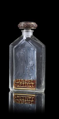 a glass bottle that has a picture of a woman on it