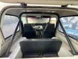 a view of the inside of a vehicle with the driver ' s seat up