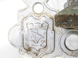 a close up of a metal object on a white surface