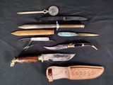 several different types of knives are lined up on a black surface