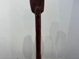 sculpture of a wooden owl on a stand on a marble surface