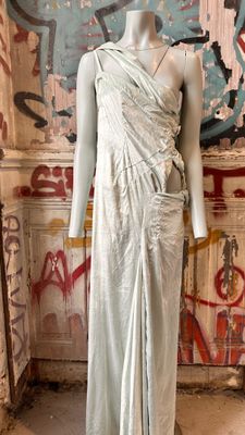 a mannequin in a room with graffiti on the walls