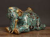 an elephant statue sitting on a table with a black background