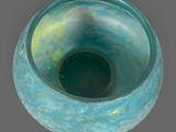 a blue vase that is sitting on a table