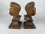 pair of carved wooden busts of a man and a woman