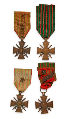 several medals and crosses are displayed on a white surface