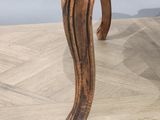 a close up of a wooden chair on a wooden floor