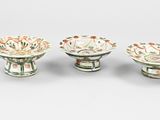 three small bowls are sitting on a table with a white background