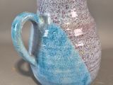 a close up of a blue and white coffee cup